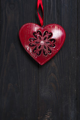 iron red heart on wooden background.