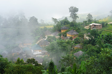 Fototapeta na wymiar Ethnic minority Ha Nhi village with adobe-style thick-walled houses with mist in Y Ty, Lao Cai province, Vietnam
