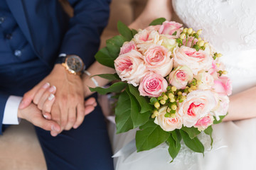 Obraz na płótnie Canvas nice wedding bouquet in bride and groom hand