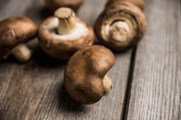 Fresh mushrooms on the rustic wooden background. Selective focus. Shallow depth of field.
