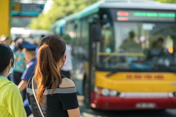 Young girl waiting for bus at bus station. Closeup. © Hanoi Photography