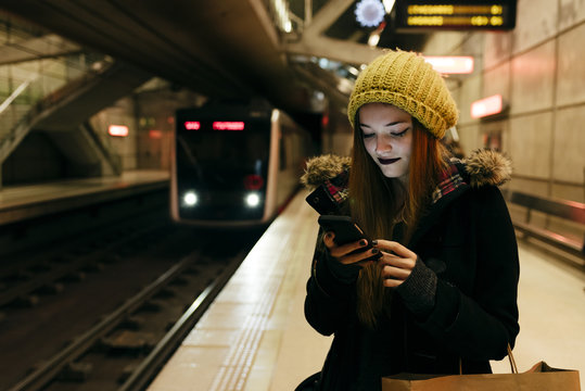 Young woman standing in subway