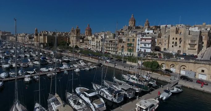 MALTA – AUGUST 2016 : Aerial shot over harbor with cityscape and open sea in view