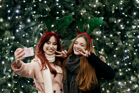 Smiling women taking selfie at illumination