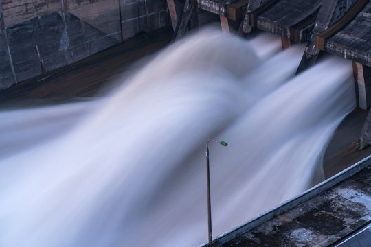Smooth draining water from the hydroelectric dam at dawn