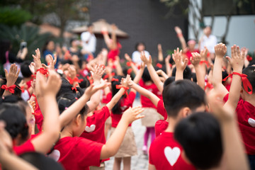 School children raising hands up on celebration day