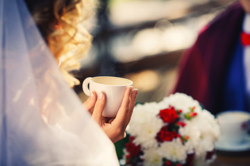 Wedding in autumn Sunny day, the couple drinking coffee in cafe