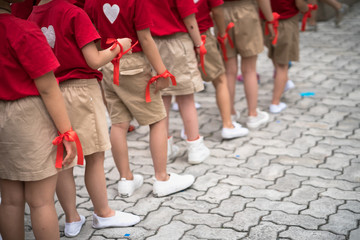 Fototapeta na wymiar Uniformed children aligned legs