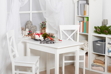 white room interior with christmas decoration, window, table and chair