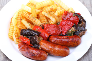 French fries and sausage on the dish