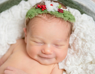 Sweet baby girl smiles while sleeping