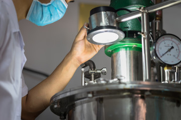Closeup Asian worker working with ferment machine