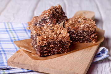 Chocolate energy bars with rolled oats, pecan nuts, dates, chia seeds and coconut flakes, horizontal