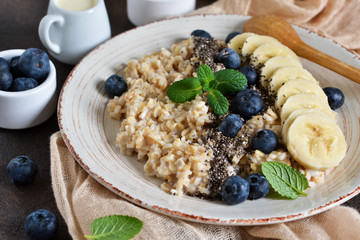Homemade breakfast: oatmeal with chia seeds, banana and blueberries.