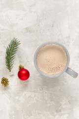Fir toy, fir branches and cup of cocoa on concrete background