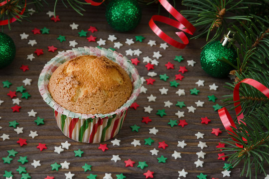 Homemade muffin with star decoration on wooden background.