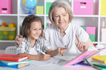 Fototapeta premium granny with grandchildren doing homework