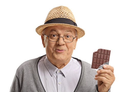 Happy mature man holding a bitten chocolate bar