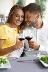 Couple In Love Drinking Wine In Restaurant.
