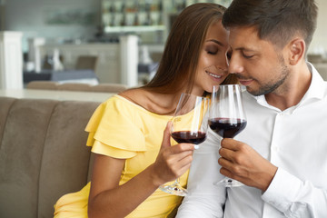 Couple In Love Drinking Wine In Restaurant.