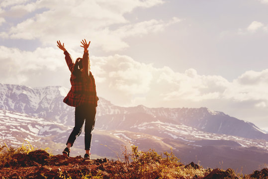 Happy Woman With Raised Hands On Background Of Mountain's Sunset