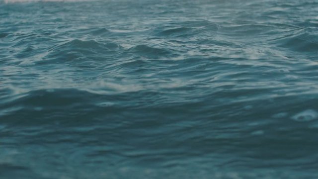 Slow motion video of sea water surface. Dackground for movie credits or intro