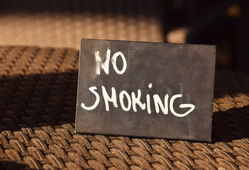 Non smoking sign on a table in a cafe