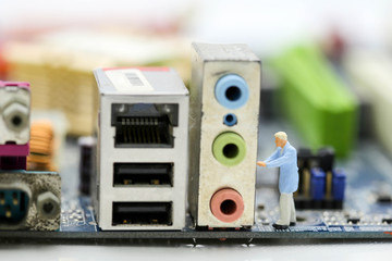 Fototapeta premium Miniaturowe osoby: inżynier i pracownik pracujący nad koncepcją bitcoin płyty głównej komputera.