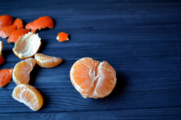 Tangerine on the table. Mandarin orange on the wooden background. Healthy food on the dark blue background.
