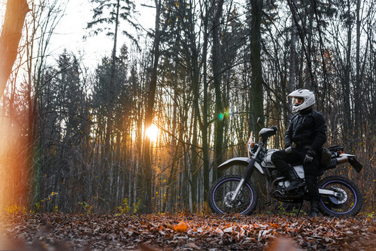 travel motorcycle off road Motorcyclist gear, A motorcycle driver looks in autumn forest, adventure concept, active lifestyle, enduro, end of season, dual sport, touring, cold weather, fog, helmet