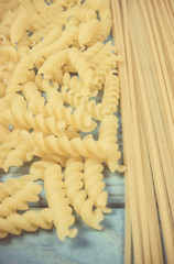 Mix of pasta on wooden background. Diet and food concept.