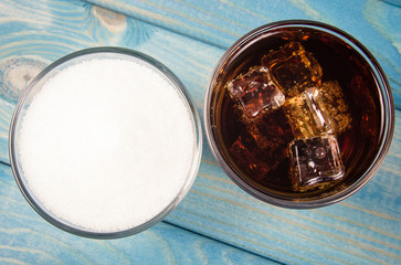 Carbonated drink with ice. The concept of sugar content in sweetened beverages.