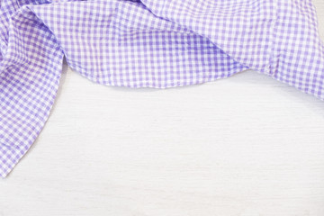 folded cyan tablecloth on bleached wooden table