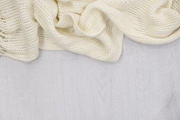 Flat lay of scarf with Christmas tartan texture and branch of tree on wooden background with space in middle - Christmas or New Year background