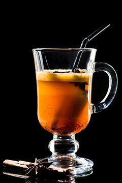 Hot Buttered Becherovka cocktail with honey, cinnamon and anise Isolated on black background