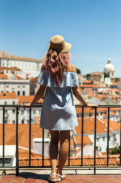 Young woman looking at Lisbon city panorama of Alfama on trip