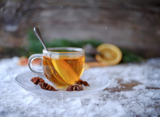 red lemon tea in glass Cup on a snowy table