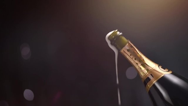 Champagne explosion. Sparkling wine popping, opening champagne bottle closeup. Slow motion. 4K UHD video footage. 3840X2160