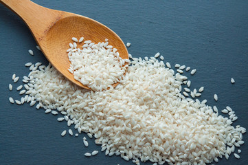 rice grains on a wooden spoon
