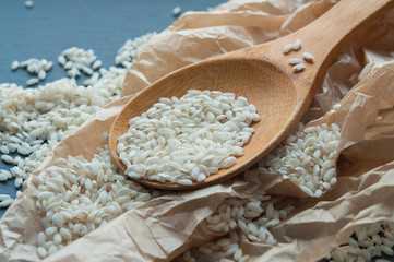 rice grains on a wooden spoon