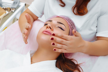 Fototapeta na wymiar Cosmetic massage, facial treatment.