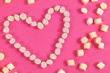 marshmallow sweets placed in heart shape.valentine's day and love concept on pink background