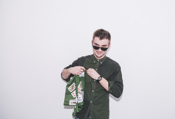 man wearing green shirt, sunglasses and holding green handkerchief