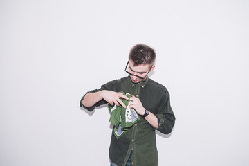 man wearing green shirt, sunglasses and holding green handkerchief