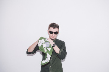 man wearing green shirt, sunglasses and holding green handkerchief