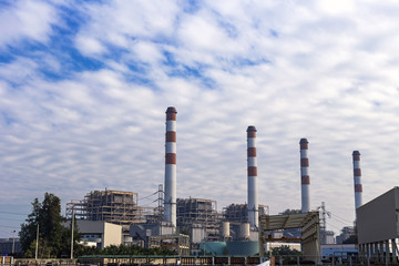 Power plant in the morning light with clouds sky background.