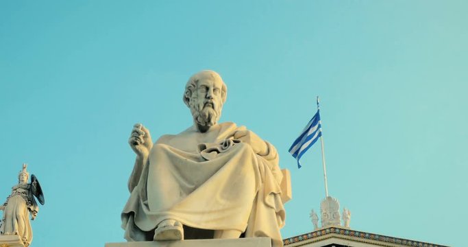 Marble statue of the Greek philosopher Plato background of Greek architecture in slow motion.