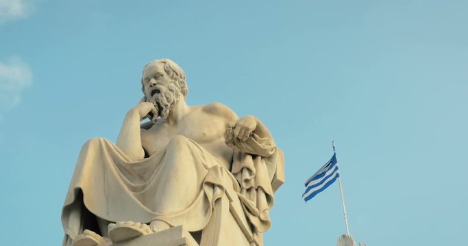 SLOW MOTION: greatest philosopher of Greece Socrates reflects on the meaning of life, on the background of Greek flag.