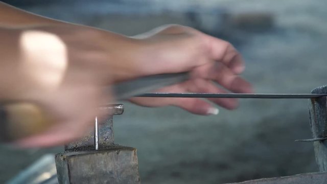Artisan Sharpens Iron Knife Blade