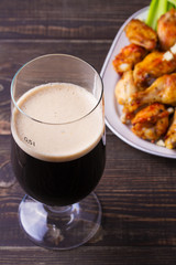 Beer and chicken wings buffalo with blue cheese and celery sticks. View from above, top, vertical